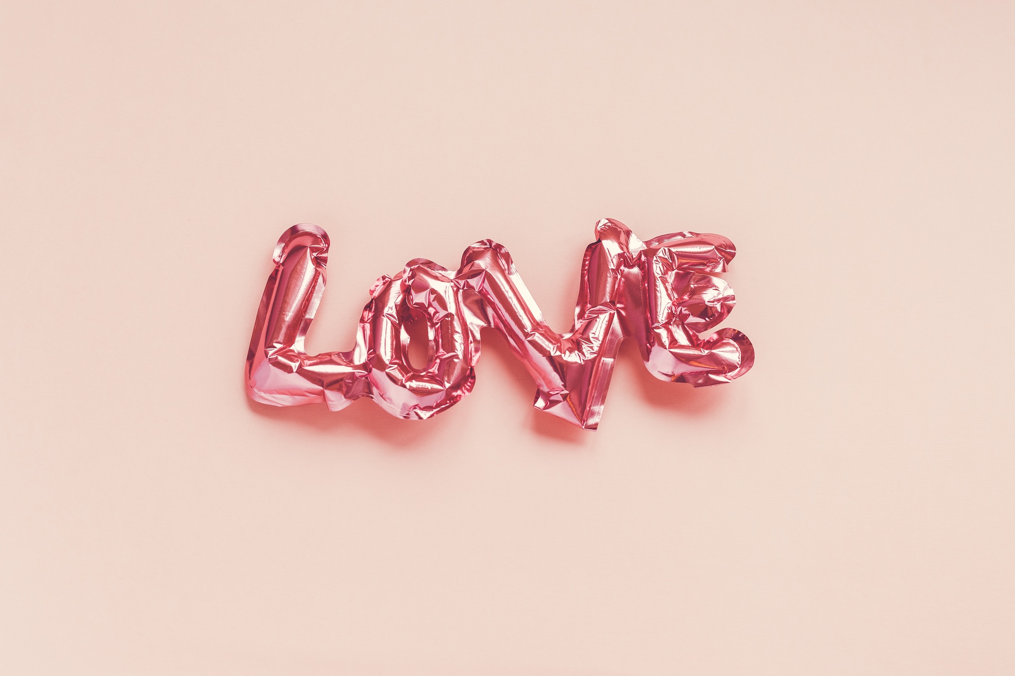 Love concept. Inflatable pink balloon with letters